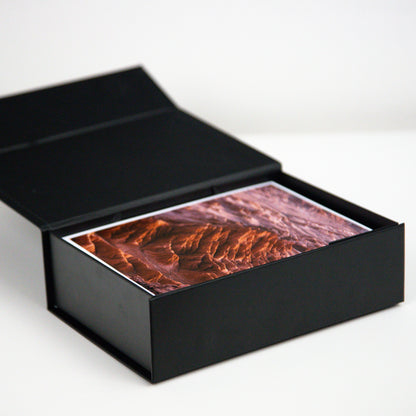 Caja de fotos negra abierta con impresión dentro